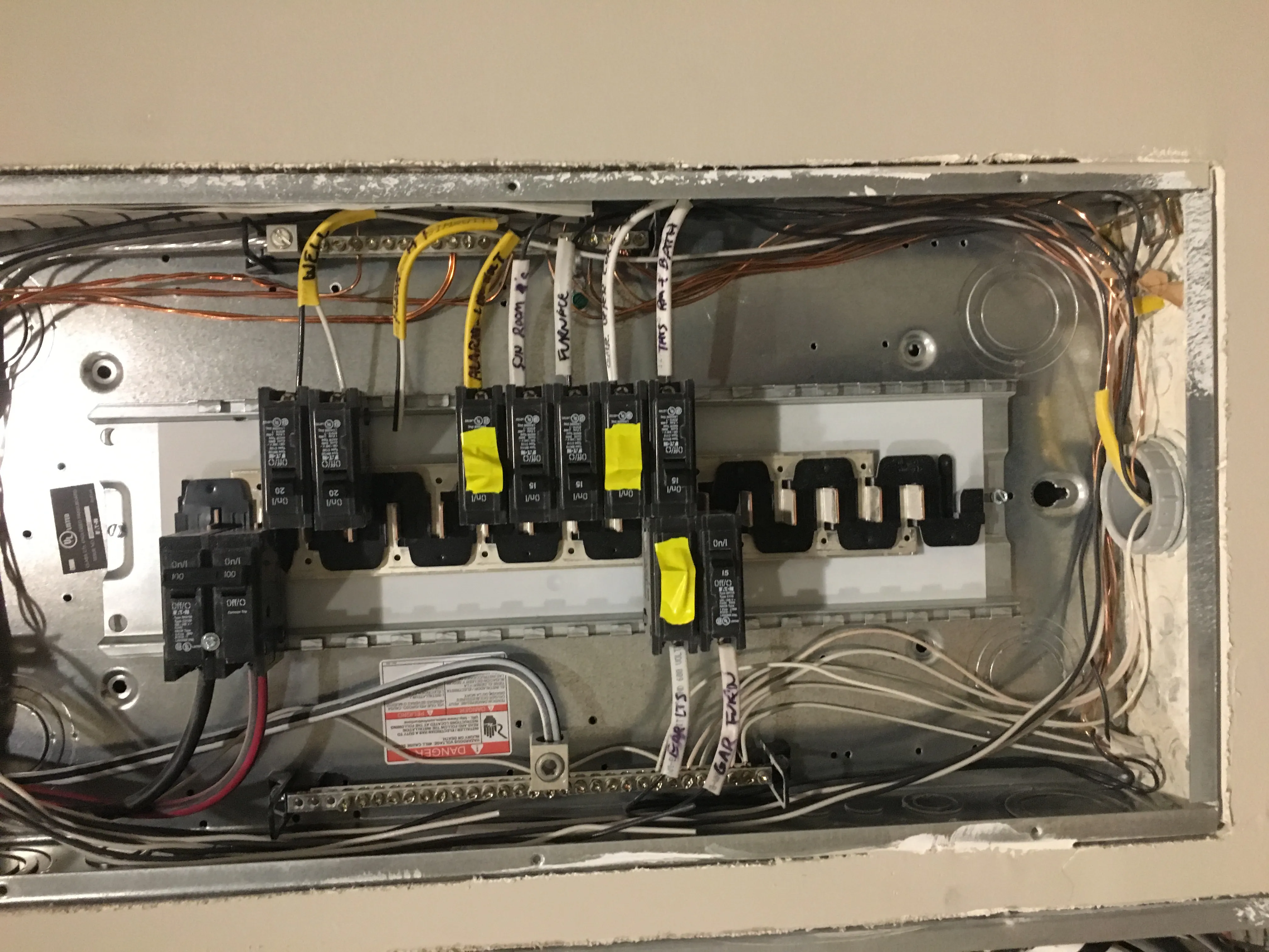 Open electrical panel with labeled branch circuits during installation